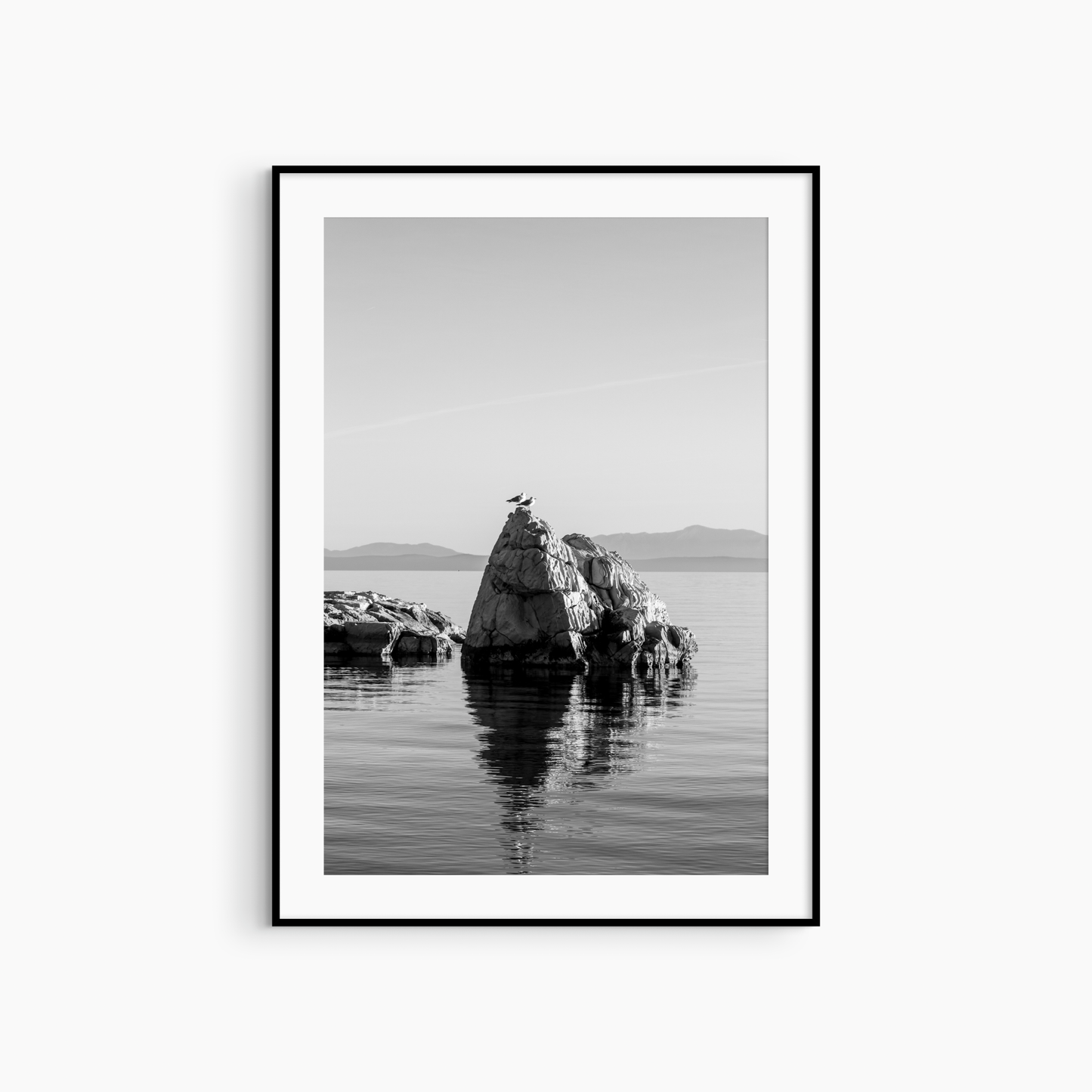 Black and white seagull photography print, silhouetted rock formation coastal wall art, minimalist seascape