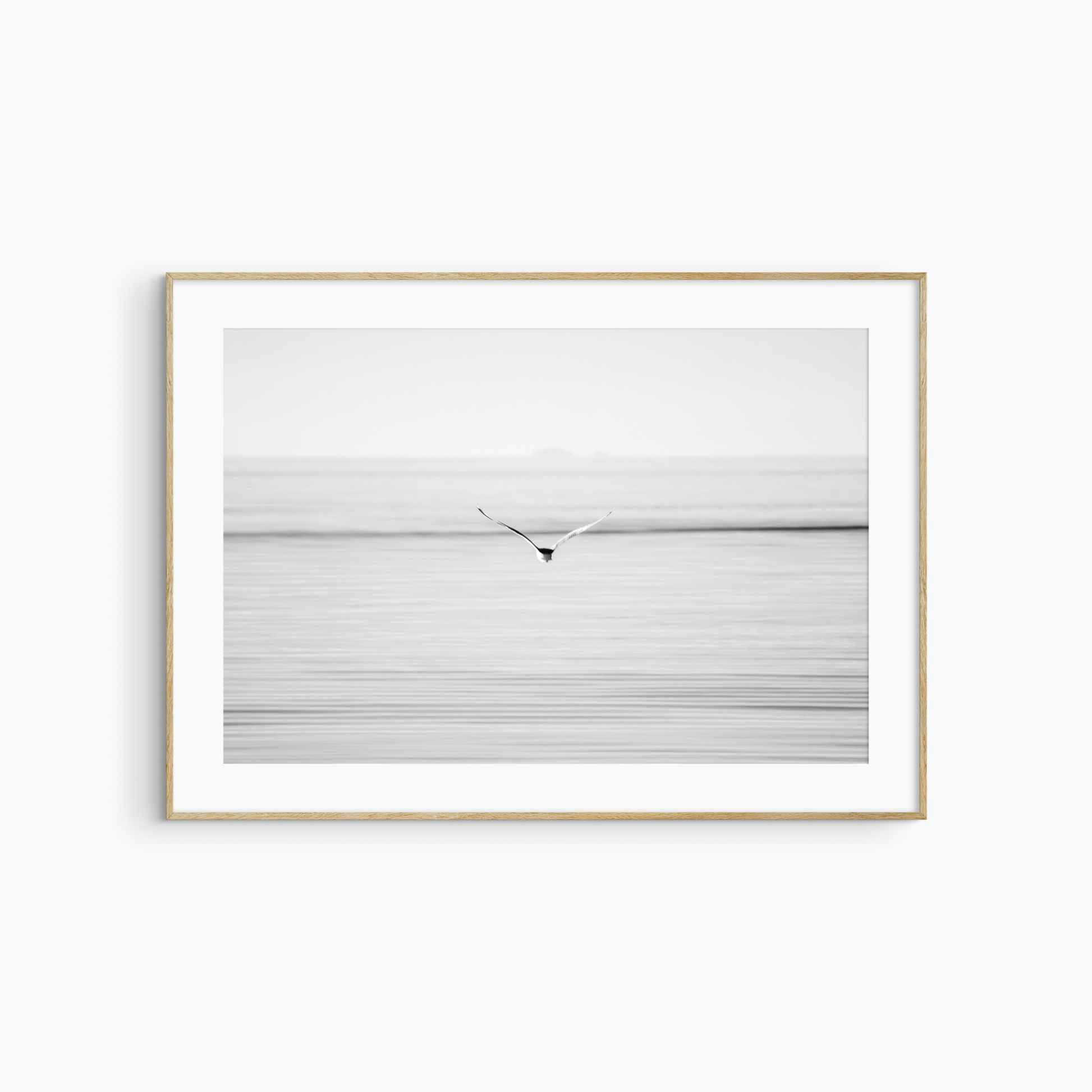 Seagull flying over sea photography print, black and white coastal wall art, printable bird print