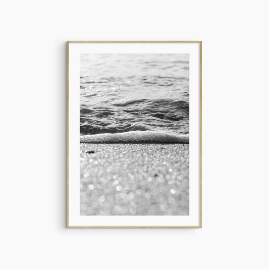 Sparkling sand and sea foam photography print, black and white coastal wall art, beach light print