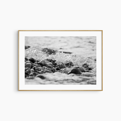 Black and white pebble shore photography print, rocky beach coastal wall art, wave and stones print