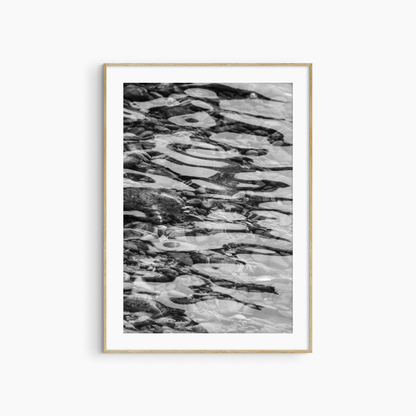 Black and white water and pebbles photography print, abstract coastal wall art, rippling water print