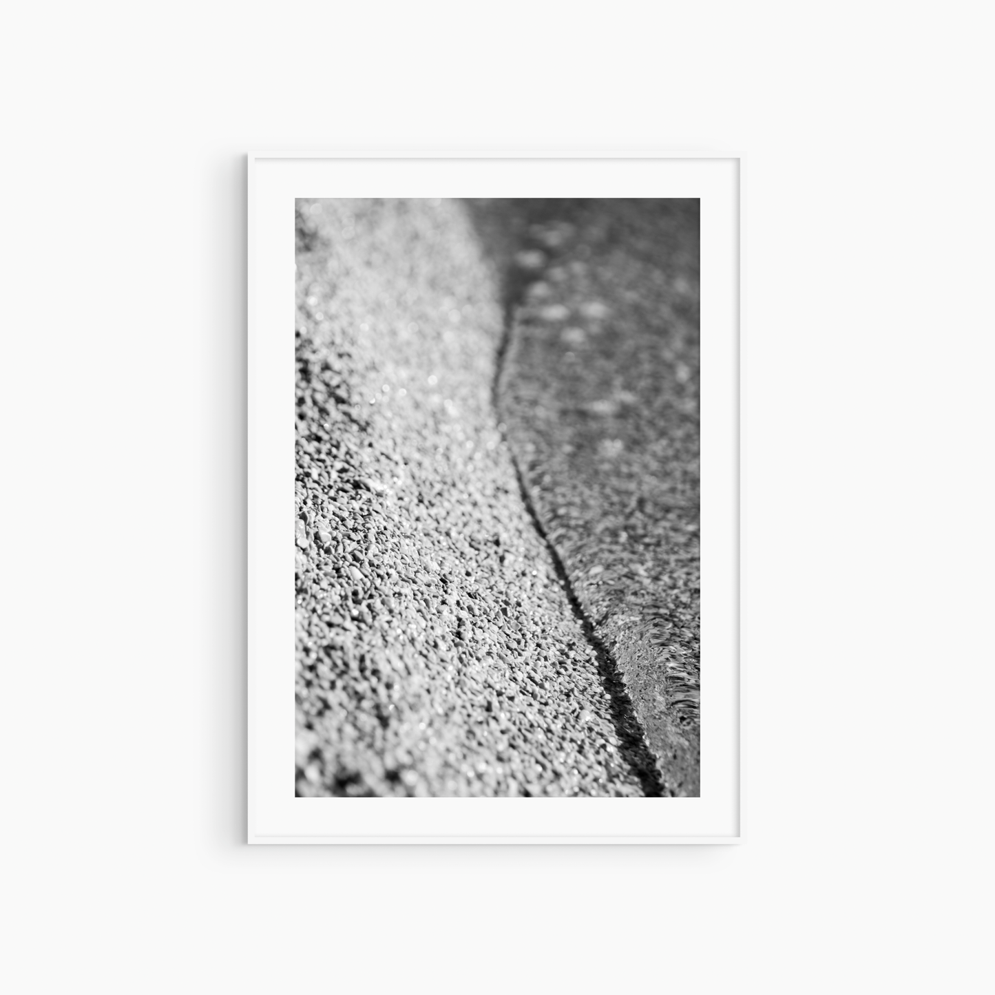 Close-up pebble shore photography print, black and white beach texture wall art, abstract coastal print