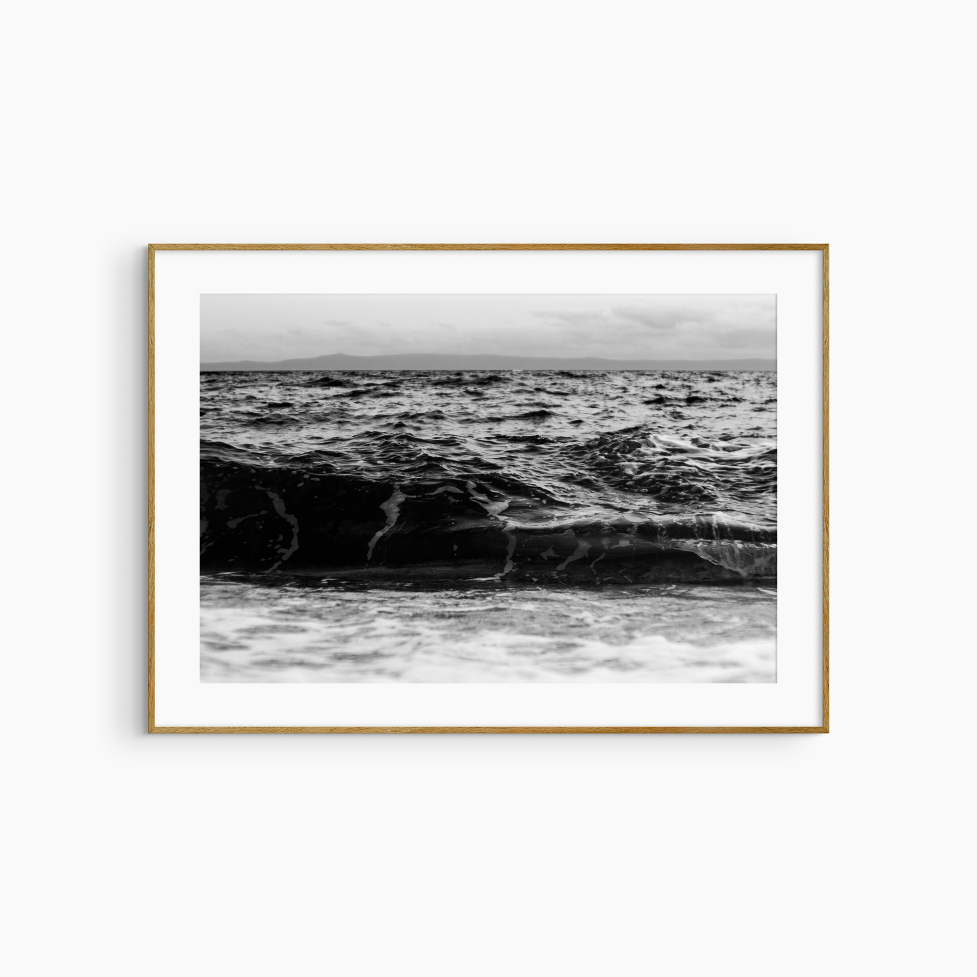 Dark rolling wave and island photography print, black and white coastal wall art, moody seascape print