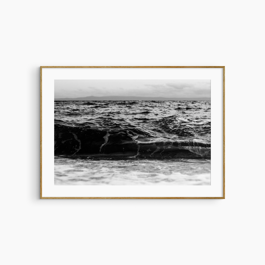Dark rolling wave and island photography print, black and white coastal wall art, moody seascape print