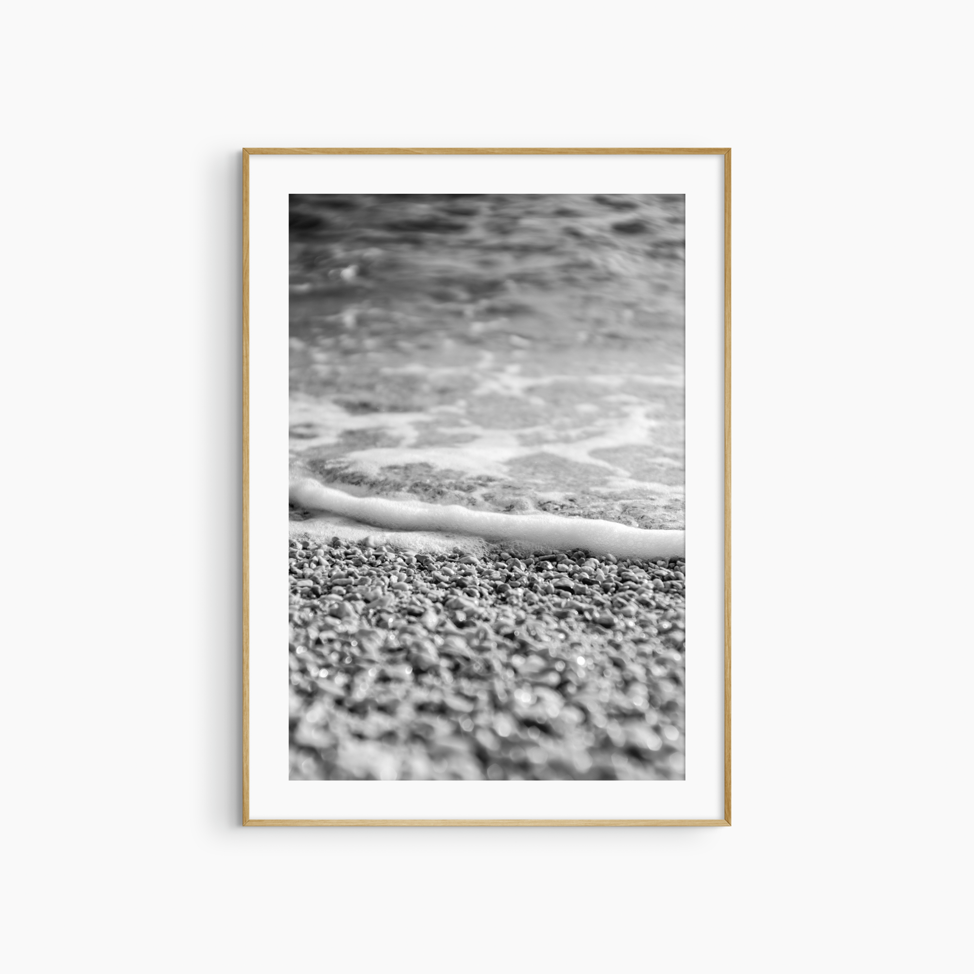 Close-up pebble shore photography print, black and white coastal wall art, foam edge beach print