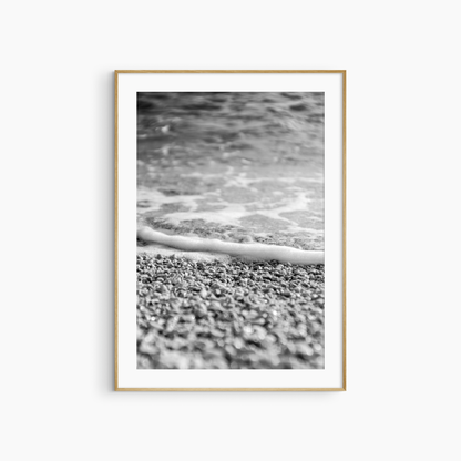 Close-up pebble shore photography print, black and white coastal wall art, foam edge beach print