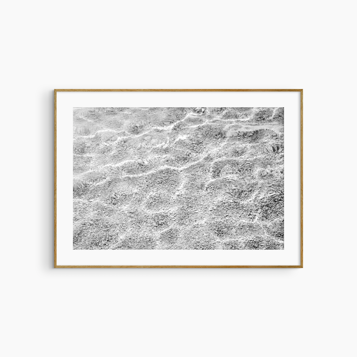 Shallow water over pebble shore photography print, black and white abstract wall art, coastal light print