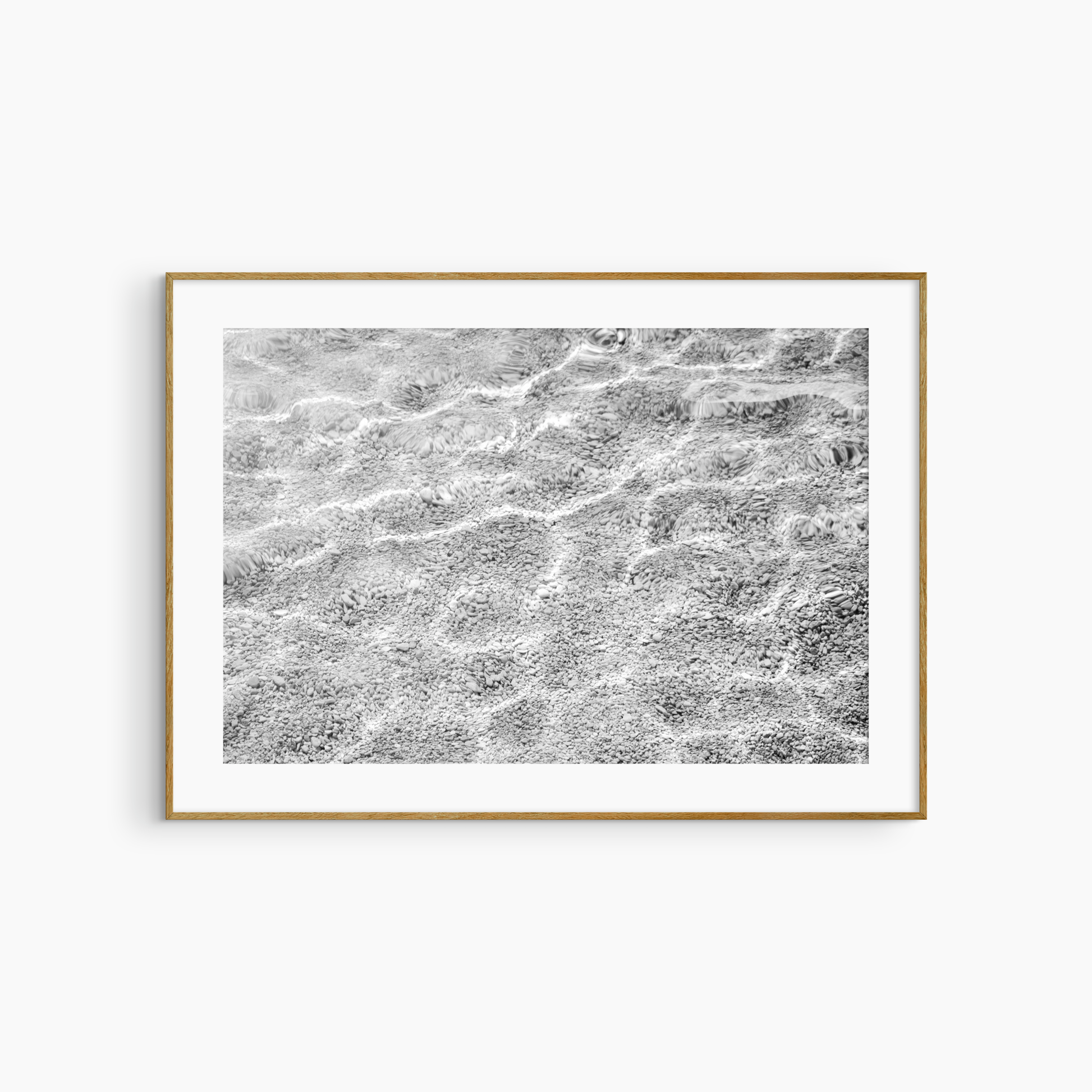 Shallow water over pebble shore photography print, black and white abstract wall art, coastal light print