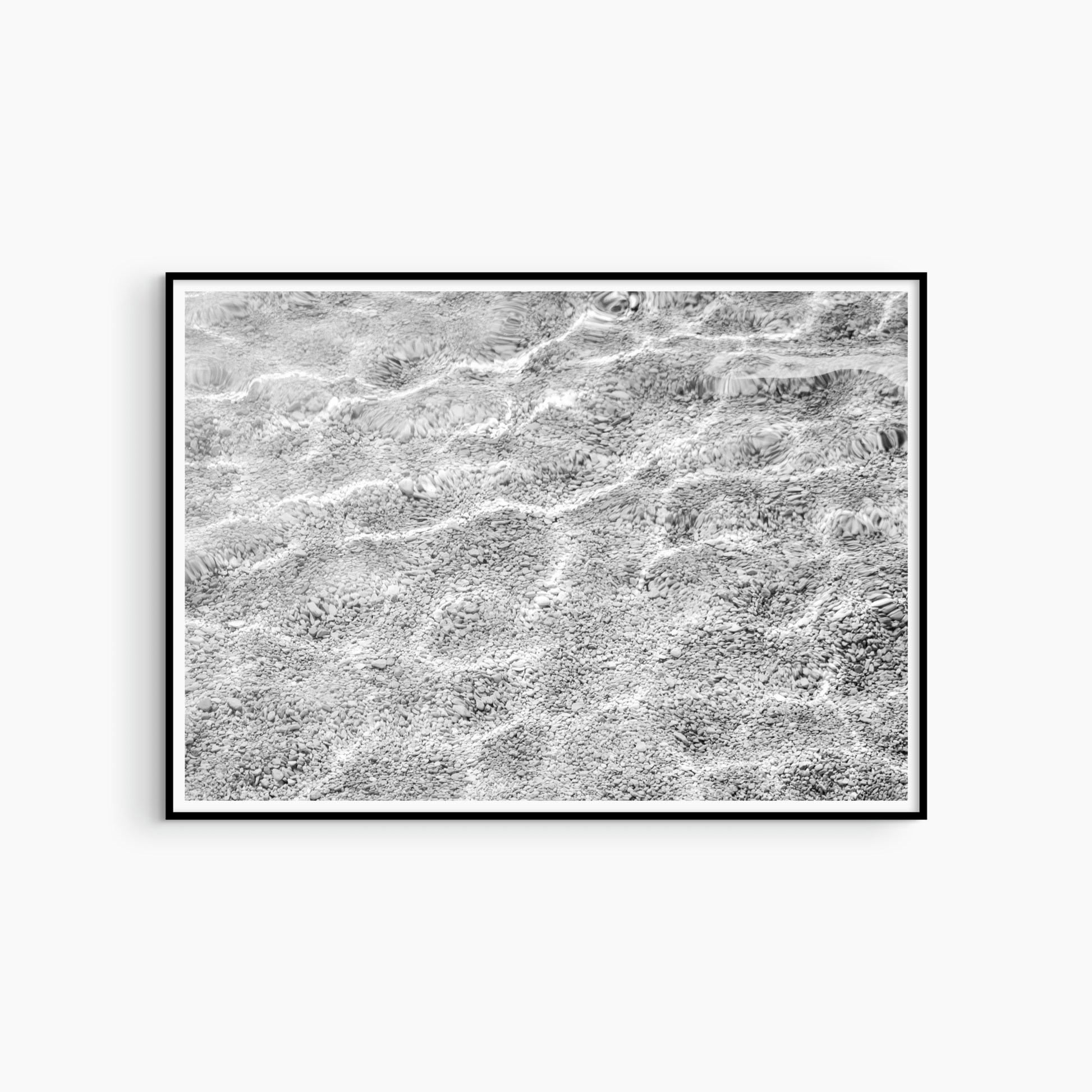 Black and white pebble shore and water photography print, abstract coastal wall art, luminous shore print