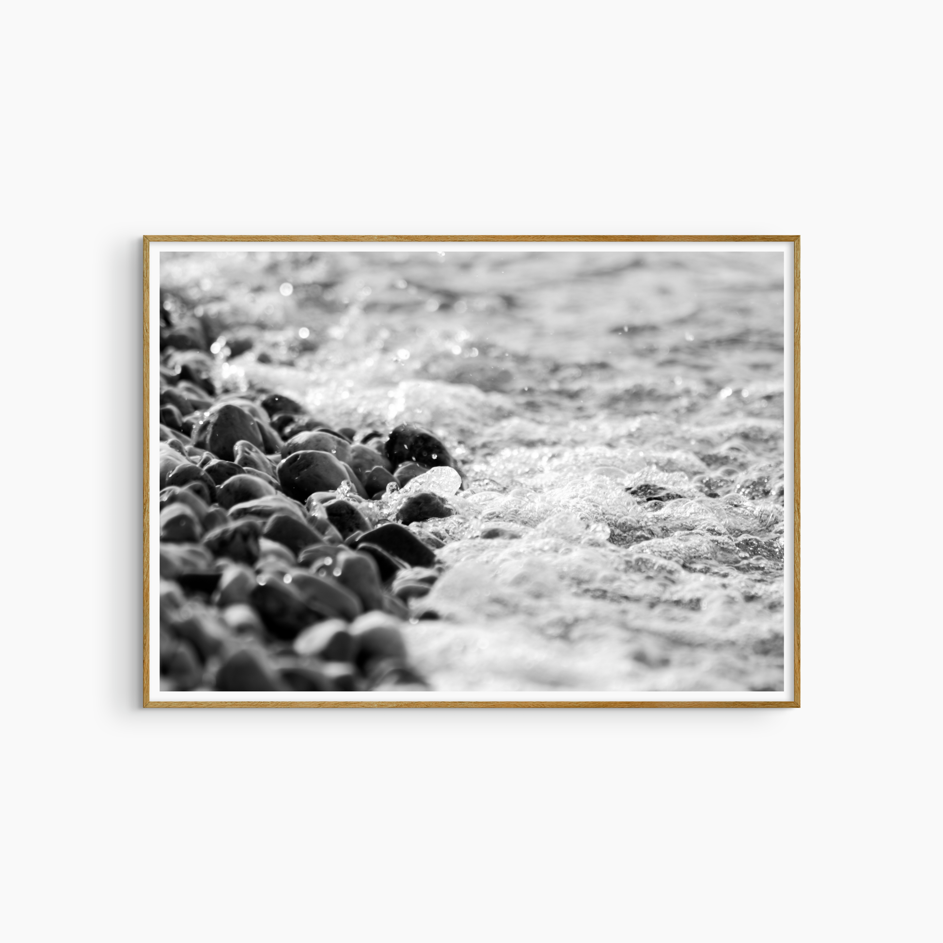 Dark wet pebbles and sea foam photography print, black and white coastal wall art, shore texture print
