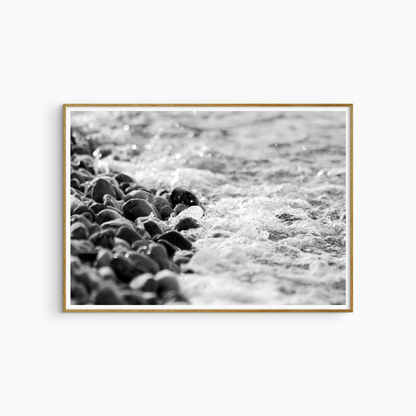 Dark wet pebbles and sea foam photography print, black and white coastal wall art, shore texture print